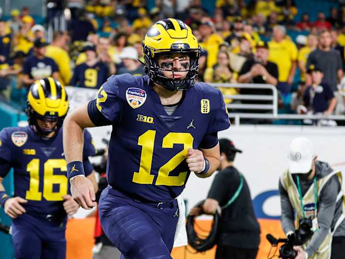 Michigan QB Cade McNamara runs onto the field