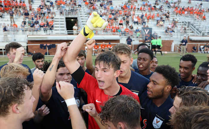The Virginia men's soccer team huddles before its season-opening match against Xavier at Klockner Stadium.