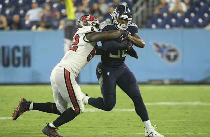 Tampa Bay Buccaneers running back Giovani Bernard (25) tackles Tennessee Titans running back Julius Chestnut (36) during the second half at Nissan Stadium.