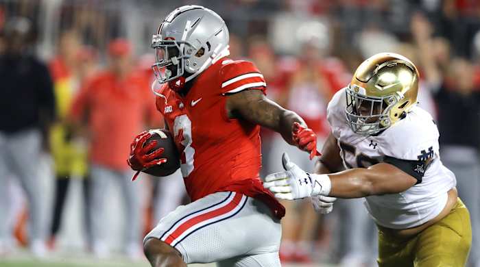 Ohio State Buckeyes running back Miyan Williams (3) runs for the first down past Notre Dame Fighting Irish defensive lineman Jayson Ademilola (57) during the fourth quarter at Ohio Stadium.