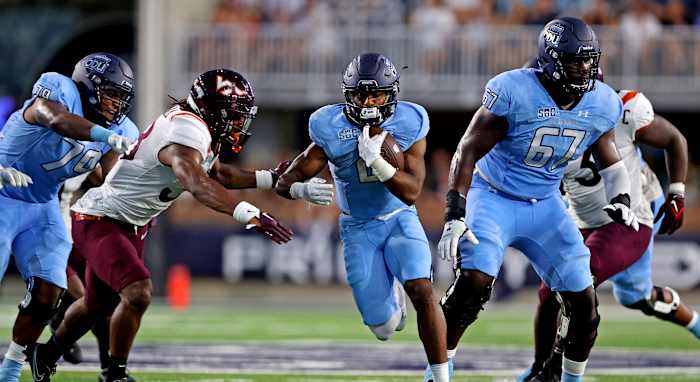 Old Dominion Monarchs running back Blake Watson (2) runs the ball against Virginia Tech Hokies linebacker Jayden McDonald (38) during the first quarter at Kornblau Field at S.B. Ballard Stadium.