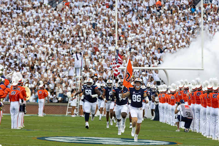 Luke Deal and Jalil Irvin lead the Auburn football team out on the field against Mercer.