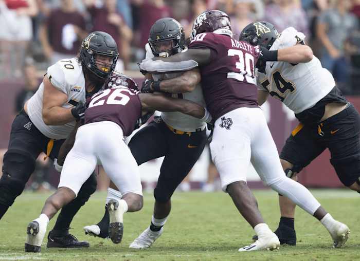 Sep 10, 2022; College Station, Texas, USA; Appalachian State Mountaineers running back Camerun Peoples (6) rushes against Texas A&M Aggies defensive lineman Tunmise Adeleye (30) in the second quarter at Kyle Field. Mandatory Credit: Thomas Shea-USA TODAY Sports