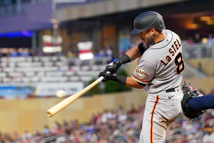 SF Giants infielder Tommy La Stella hits a sacrifice fly against the Twins.