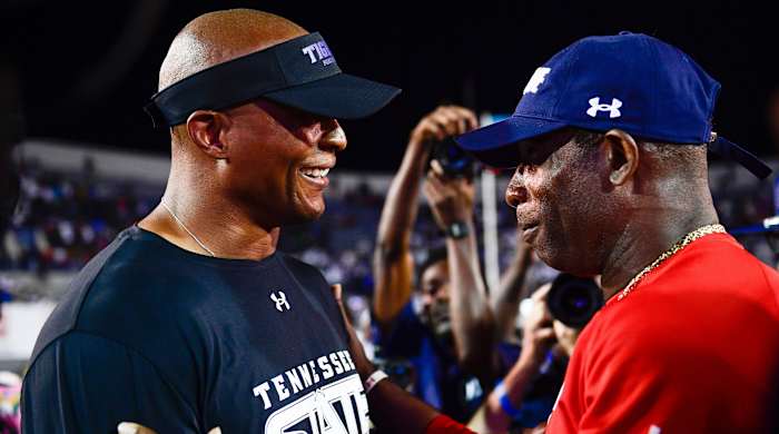 Eddie George and Deion Sanders meet after the game.