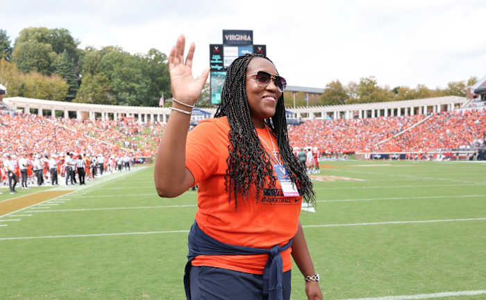 Virginia women's basketball head coach Amaka Agugua-Hamilton waves to the crowd at Scott Stadium during the UVA football game against Richmond.