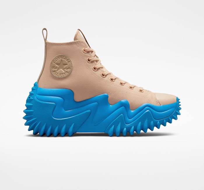 View of tan and blue Converse shoe.