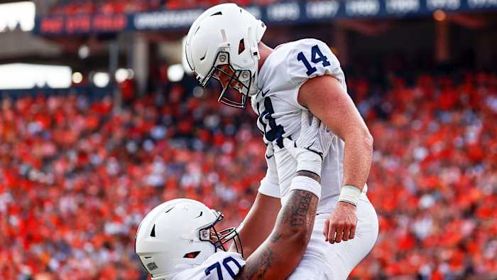 Penn State QB Sean Clifford is lifted by a teammate