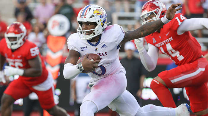 Kansas Jayhawks quarterback Jalon Daniels (6) runs with the ball for a first down during the second quarter against the Houston Cougars at TDECU Stadium.