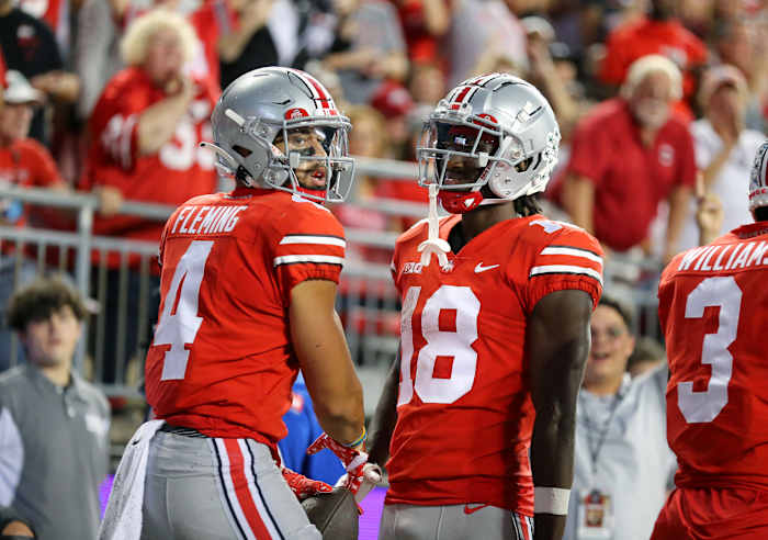 Ohio State wide receivers Julian Fleming (No. 4) and Marvin Harrison Jr. (No. 18) celebrate a touchdown against Toledo.