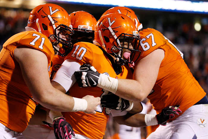 Virginia Cavaliers running back Jordan Ellis (10) celebrates with teammates after scoring the game winning touchdown against the Syracuse Orange in the third overtime at Scott Stadium. The Cavaliers won 44-38 in triple overtime.