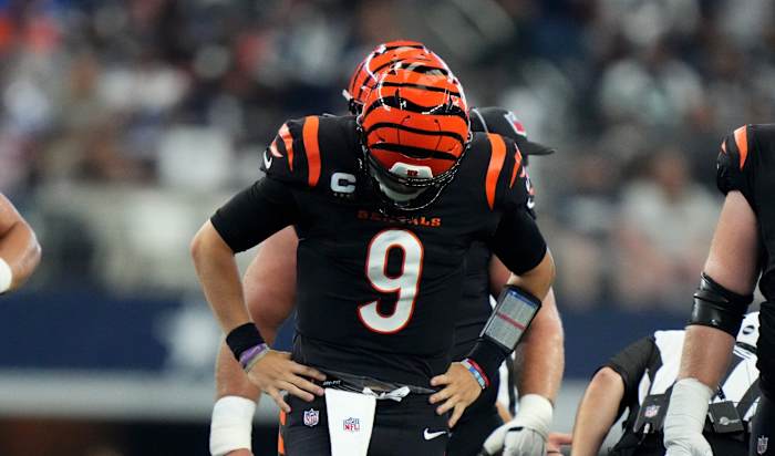 Cincinnati Bengals quarterback Joe Burrow (9) gets up slowly and looks down at this foot after a sack in the third quarter of an NFL Week 2 game against the Dallas Cowboys, Sunday, Sept. 18, 2022, at AT&T Stadium in Arlington, Texas. The Dallas Cowboys won, 20-17. Nfl Cincinnati Bengals At Dallas Cowboys Sept 18 2435