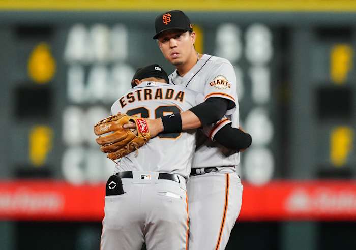 SF Giants infielders Wilmer Flores and Thairo Estrada embrace. (2022)