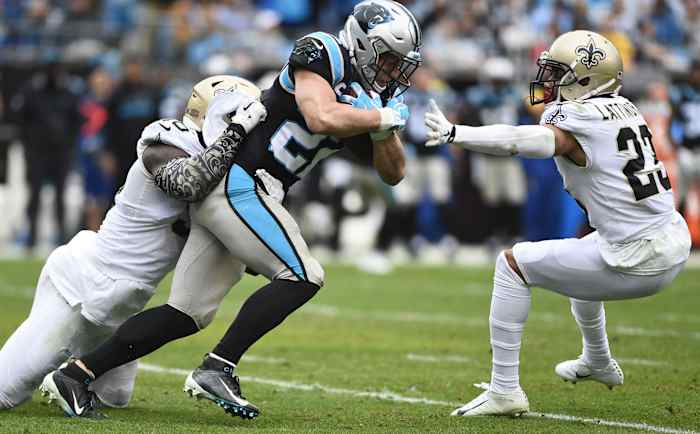 Carolina Panthers running back Christian McCaffrey (22) is tackled by New Orleans Saints linebacker Demario Davis (56) and cornerback Marshon Lattimore (23). Mandatory Credit: Bob Donnan-USA TODAY
