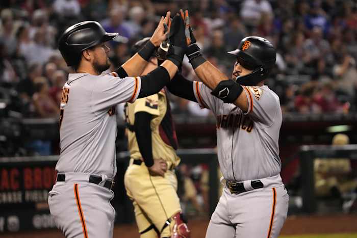 SF Giants corner infielders David Villar and J.D. Davis high-ten after a home run against the Diamondbacks. (2022)