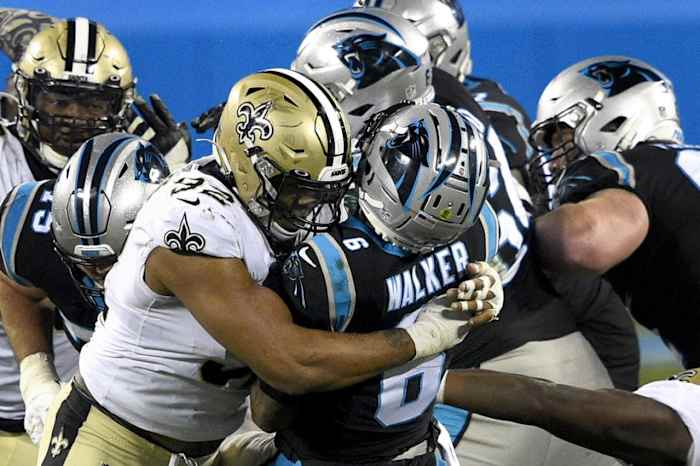 Jan 3, 2021; Carolina Panthers quarterback P.J. Walker (6) throws an interception as he is hit by New Orleans Saints defensive end Marcus Davenport (92). Mandatory Credit: Bob Donnan-USA TODAY