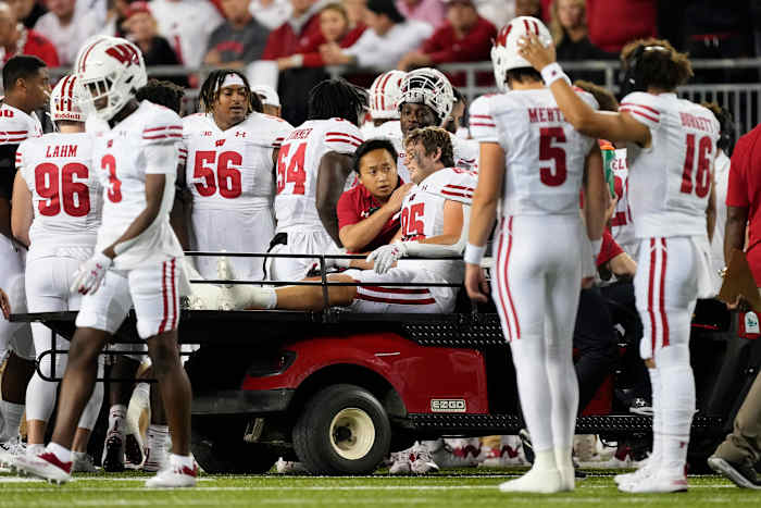 Wisconsin tight end Clay Cundiff being carted off the field against Ohio State.