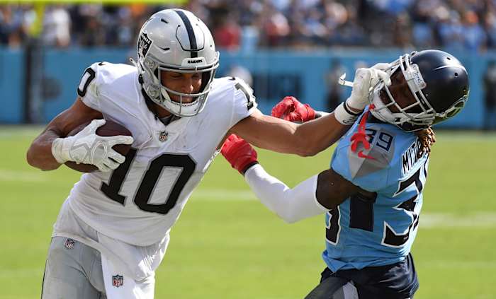 Las Vegas Raiders wide receiver Mack Hollins (10) pushes off on a tackle attempt by Tennessee Titans cornerback Terrance Mitchell (39) during the second half at Nissan Stadium.