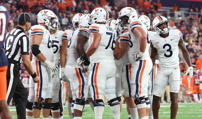 The Virginia Cavaliers offense huddles before a play during the game at Syracuse.