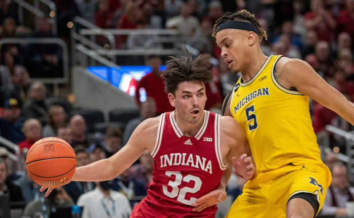Indiana Hoosiers guard Trey Galloway (32) is defended by Michigan Wolverines forward Terrance Williams II (5), Thursday, March 10, 2022, during Big Ten tournament men s action from Indianapolis Gainbridge Fieldhouse. Indiana won 74-69.