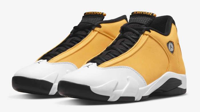 View of yellow, white, and black Air Jordan 14 shoes.