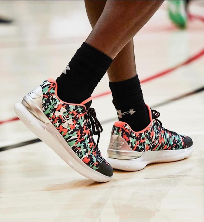 View of black, green, and red Curry One Low shoes.