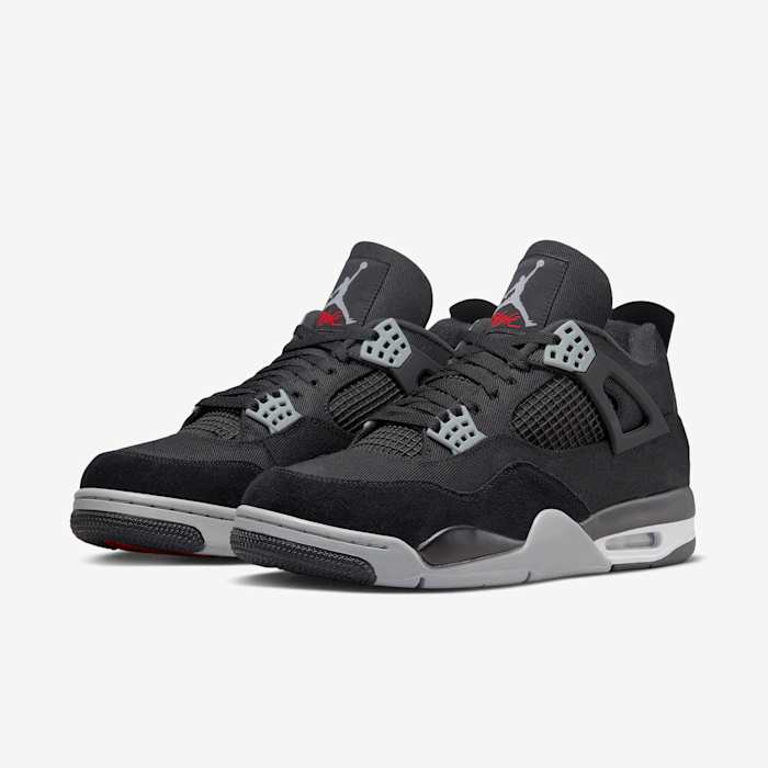 View of black and grey Air Jordan 4 shoes.