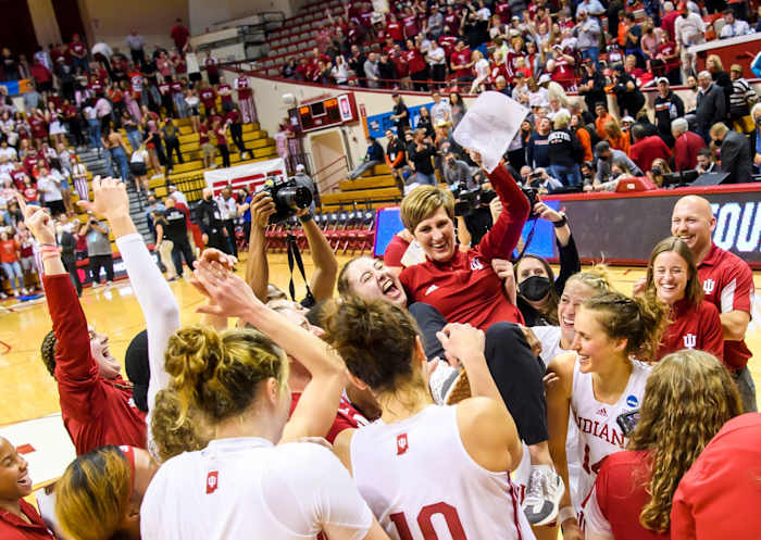 Teri Moren is lifted up by her team.