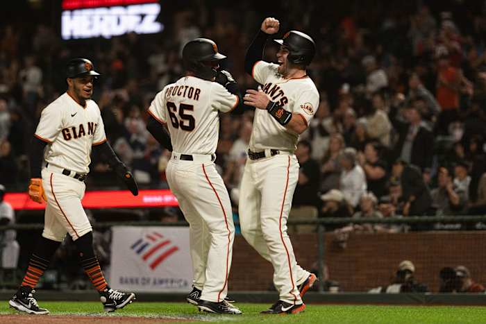 SF Giants second baseman Ford Proctor (65) celebrates with catcher Austin Wynns (14) after hitting a grand slam during the second inning against the Rockies. (2022)
