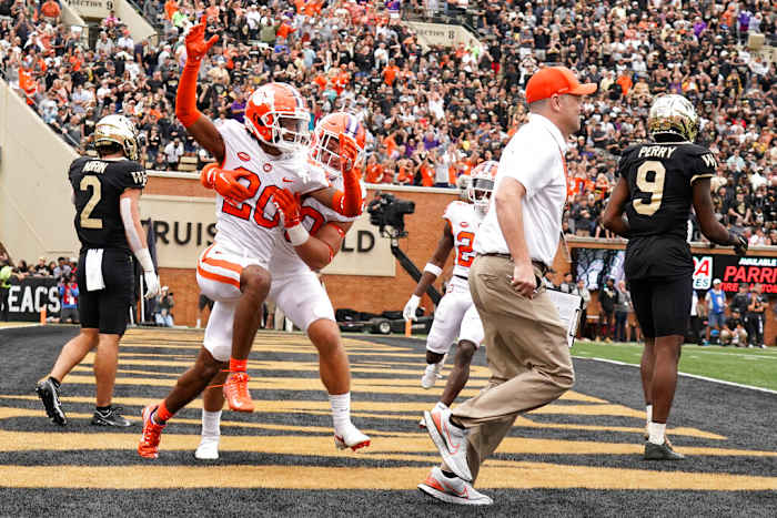 Clemson cornerback Nate Wiggins (20) is congratulated by teammate Keith Maguire (30) after knocking down a fourth down pass intended for Wake Forest wide receiver A.T. Perry (9) during the second overtime of an NCAA college football game in Winston-Salem, N.C., Saturday, Sept. 24, 2022. Clemson won 51-45 in double overtime. (AP Photo/Chuck Burton)