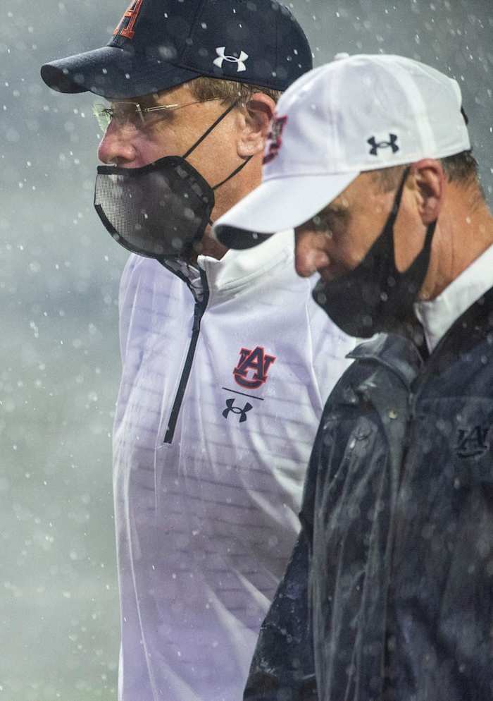 Auburn coach Gus Malzahn and offensive coordinator Chad Morris walk off the field at Jordan Hare Stadium in Auburn, Ala., on Saturday, Oct. 10, 2020. Auburn defeated Arkansas 30-28. 
