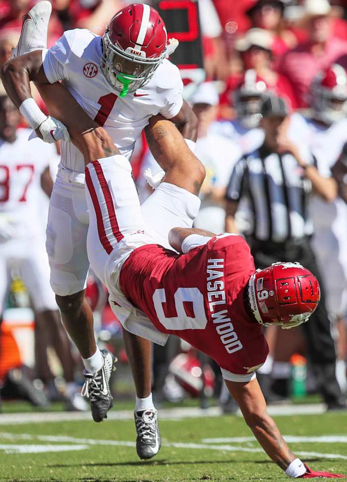 Arkansas wide receiver Jadon Haselwood is dumped onto his shoulder in a home game against Alabama.