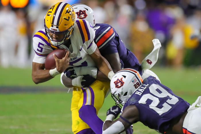 Auburn Tigers linebacker Derick Hall (29) and Auburn Tigers defensive end Colby Wooden (25) take down LSU Tigers quarterback Jayden Daniels (5) during the game between the LSU Tigers and the Auburn Tigers at Jordan-Hare Stadium on Oct. 1, 2022.