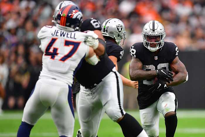 Las Vegas Raiders running back Josh Jacobs (28) runs the ball against the Denver Broncos during the first half at Allegiant Stadium.