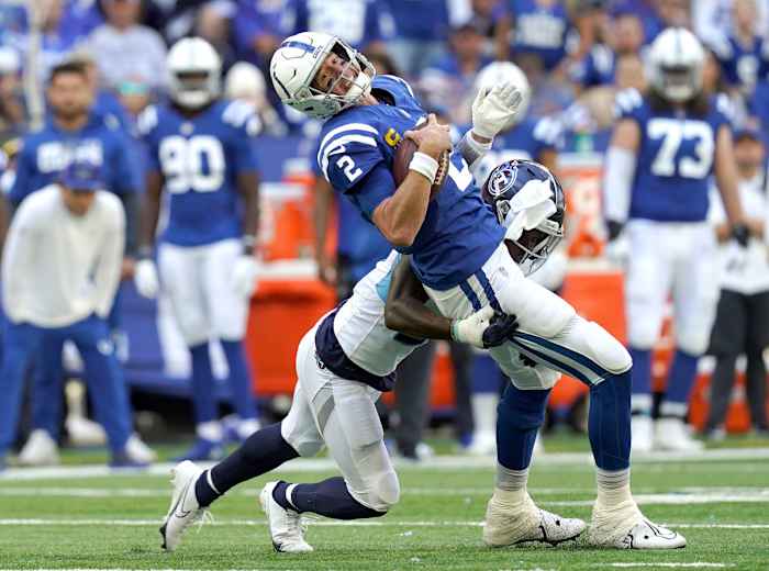 Oct 2, 2022; Indianapolis, Indiana, USA; Tennessee Titans cornerback Roger McCreary (21) tackles Indianapolis Colts quarterback Matt Ryan (2) during the first half at Lucas Oil Stadium. Mandatory Credit: Armond Feffer/IndyStar-USA TODAY NETWORK