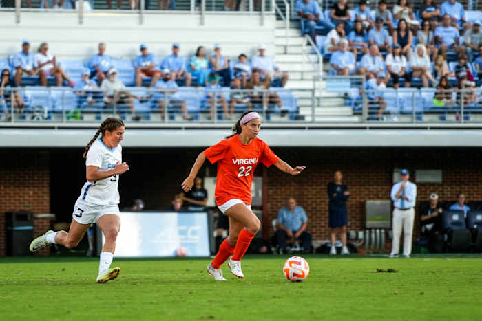 Junior midfielder Lia Godfrey dribbles the ball for the Virginia women's soccer team against North Carolina.