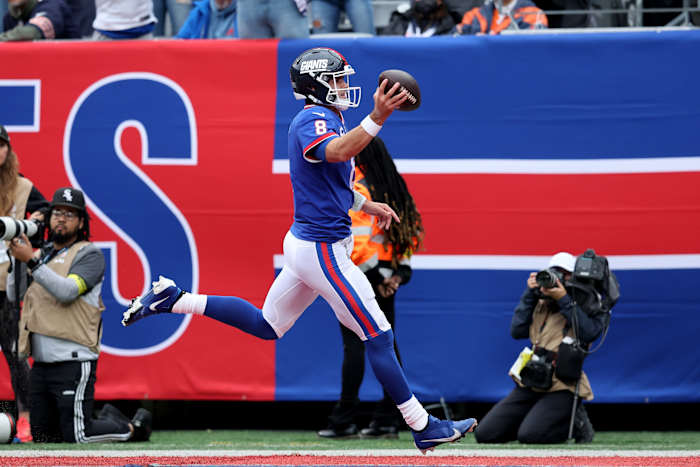 Oct 2, 2022; East Rutherford, New Jersey, USA; New York Giants quarterback Daniel Jones (8) runs for a touchdown against the Chicago Bears during the first quarter at MetLife Stadium.