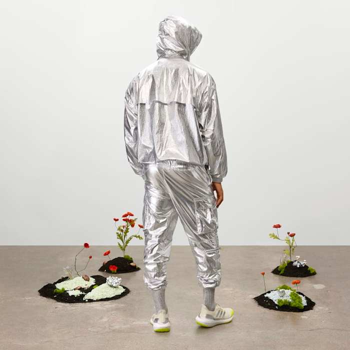 Model wearing metallic tracksuit.