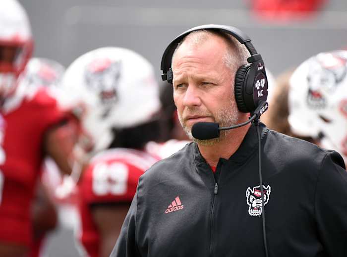 NC State head coach Dave Doeren speaking into his headset.
