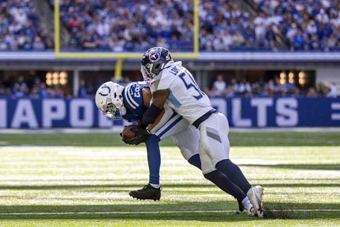 Indianapolis Colts running back Jonathan Taylor (28) is tackled by Tennessee Titans linebacker David Long Jr. (51) during the second quarter at Lucas Oil Stadium.