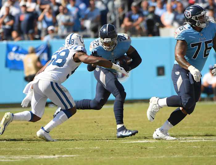 Nashville, Tennessee, USA; Tennessee Titans running back Derrick Henry (22) runs the ball as Indianapolis Colts inside linebacker Bobby Okereke (58) chases during the second half at Nissan Stadium.