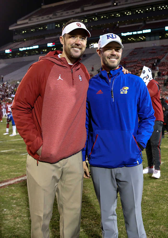 Oklahoma Sooners head coach Lincoln Riley (left) takes a photo with his brother Kansas Jayhawks offensive analyst Garrett Riley after the game at Gaylord Family - Oklahoma Memorial Stadium