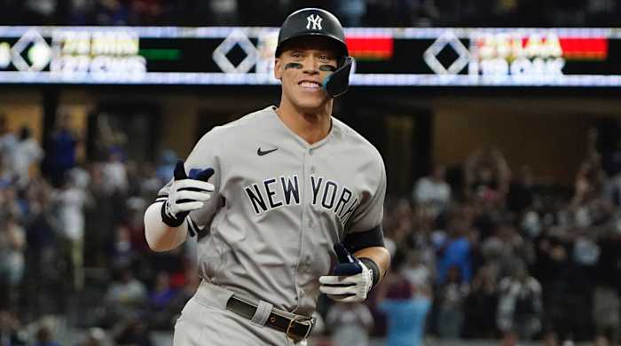 New York Yankees' Aaron Judge gestures as he rounds the bases after hitting his 62nd homer of the season
