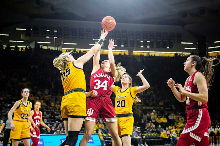 Indiana guard Grace Berger (34) shoots a basket as Iowa center Monika Czinano (25) and Iowa guard Kate Martin (20) defend while Iowa guard Caitlin Clark (22) and Indiana guard Ali Patberg, right, look on during a NCAA Big Ten Conference women's basketball game, Monday, Feb. 21, 2022, at Carver-Hawkeye Arena in Iowa City, Iowa.