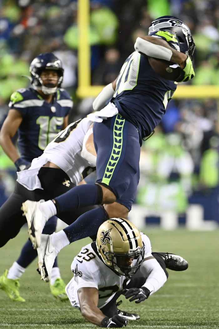 New Orleans Saints cornerback Paulson Adebo (29) tackles Seattle Seahawks running back Rashaad Penny (20). Mandatory Credit: Steven Bisig-USA TODAY Sports