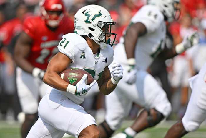 Sep 24, 2022; Louisville, Kentucky, USA; South Florida Bulls running back Brian Battie (21) runs the ball against the Louisville Cardinals during the first quarter at Cardinal Stadium. Mandatory Credit: Jamie Rhodes-USA TODAY Sports