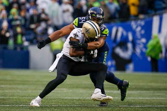 Oct 25, 2021; Former Seahawks linebacker Bobby Wagner (54) tackles New Orleans Saints tight end Juwan Johnson (83) following a reception. Mandatory Credit: Joe Nicholson-USA TODAY Sports