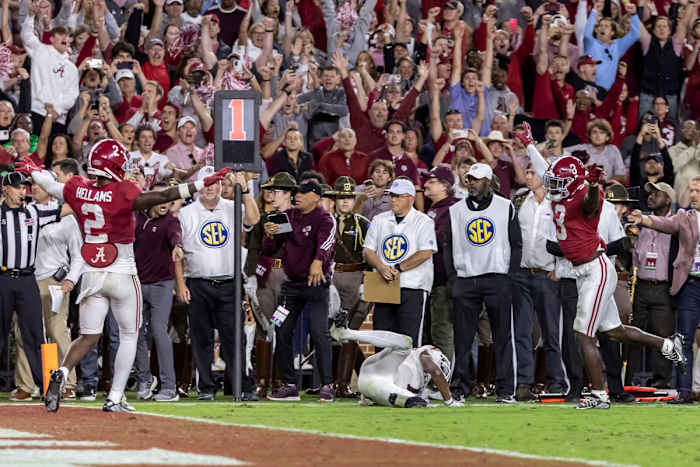 Alabama defensive backs DeMarcco Hellams and Terrion Arnold signal no catch on the final play against Texas A&M.