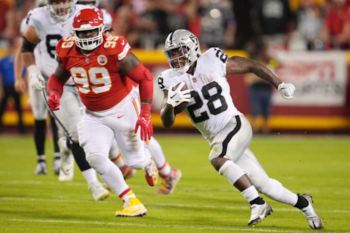 Oct 10, 2022; Kansas City, Missouri, USA; Las Vegas Raiders running back Josh Jacobs (28) runs the ball in the first half against the Kansas City Chiefs at GEHA Field at Arrowhead Stadium. Mandatory Credit: Jay Biggerstaff -USA TODAY Sports