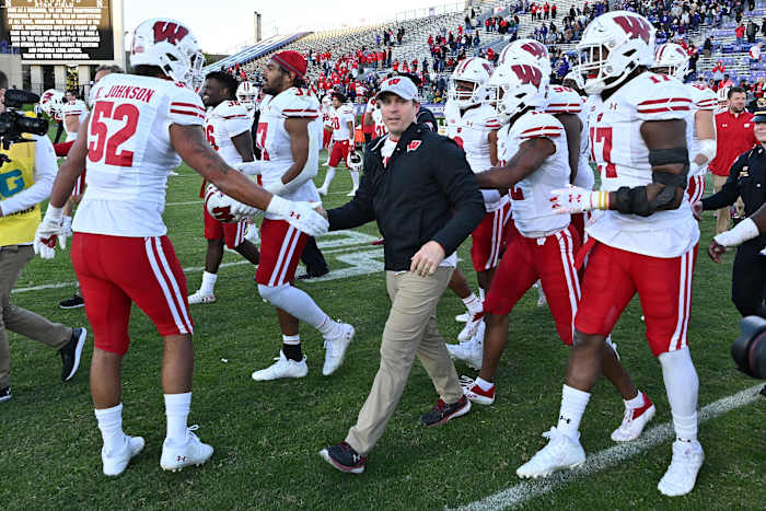 Wisconsin head coach Jim Leonhard celebrating a win with his team.